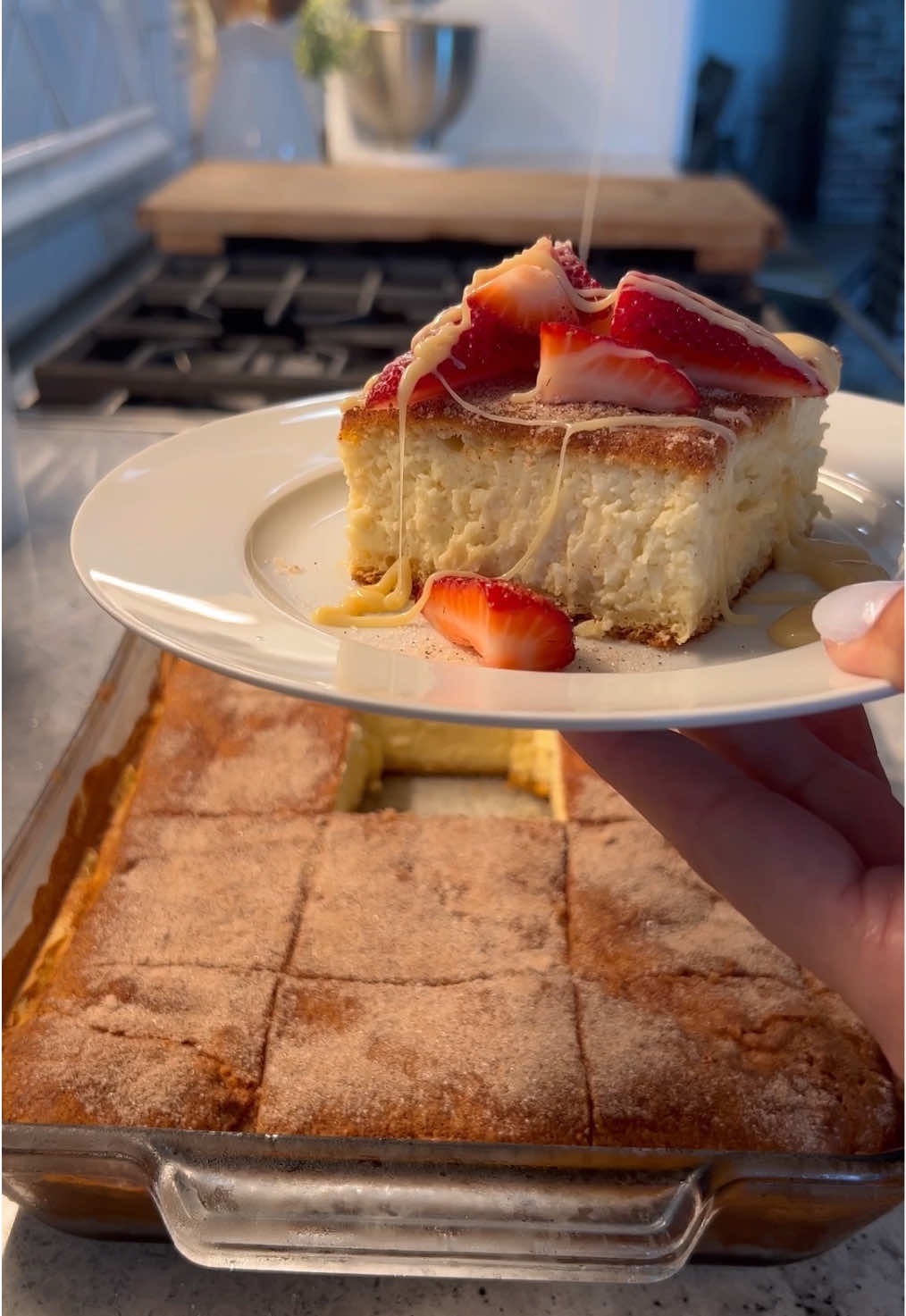 A post by @britscookin on TikTok caption: Churro Cheesecake 🍓♥️– the perfect Father’s Day dessert!  What you need: 	•	3 blocks (8 oz each) cream cheese, softened 	•	½ cup sour cream 	•	3 eggs 	•	½ tbsp vanilla extract 	•	1 can sweetened condensed milk 	•	⅓ cup sugar 	•	Pinch of cinnamon Cinnamon Sugar Mix: 	•	½ cup sugar 	•	½ tbsp cinnamon Other: 	•	2 crescent roll dough sheets 	•	Fresh strawberries (optional) 	•	Extra condensed milk for topping (optional) How to make it: 	1.	In a bowl, mix together cream cheese, sour cream, eggs, vanilla, sweetened condensed milk, ⅓ cup sugar, and a pinch of cinnamon until smooth. Set aside. 	2.	In a separate bowl, mix ½ cup sugar with ½ tbsp cinnamon. 	3.	Grease a 13x9 baking dish and sprinkle half of the cinnamon sugar on the bottom. 	4.	Lay one crescent roll sheet over the sugar. 	5.	Pour in the cheesecake filling and spread evenly. 	6.	Place the second crescent dough sheet on top, then sprinkle with the remaining cinnamon sugar. 	7.	Bake at 350°F for 40–45 minutes. 	8.	Let cool in the fridge for at least 3–4 hours before slicing. 	9.	Top with fresh strawberries and a drizzle of condensed milk (optional but so good). #easyrecipe #dessert #fathersday 
