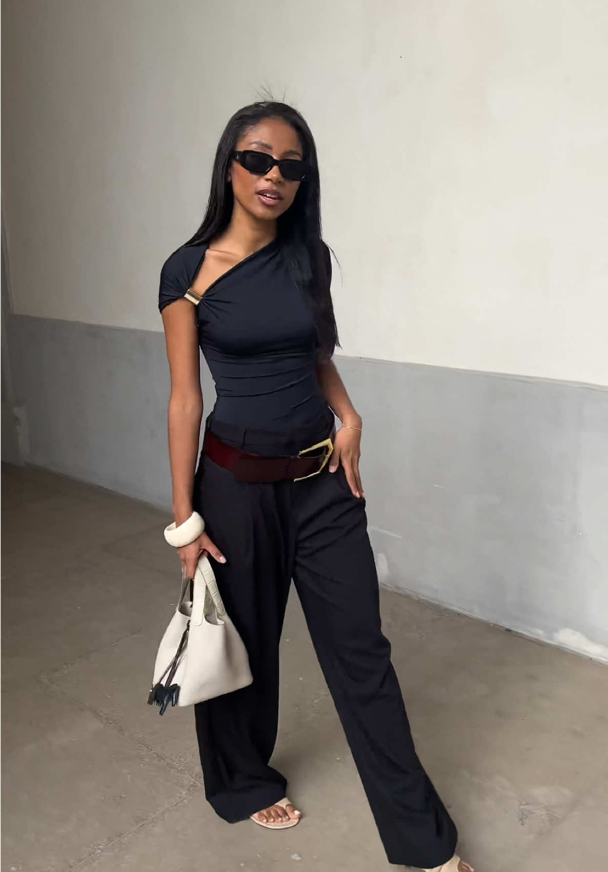 A post by @sarahndiaye on TikTok caption: Full black look for today @Stradivarius @Marcella NYC @DISSH @H&M #OOTD #hermes #picotinbag 