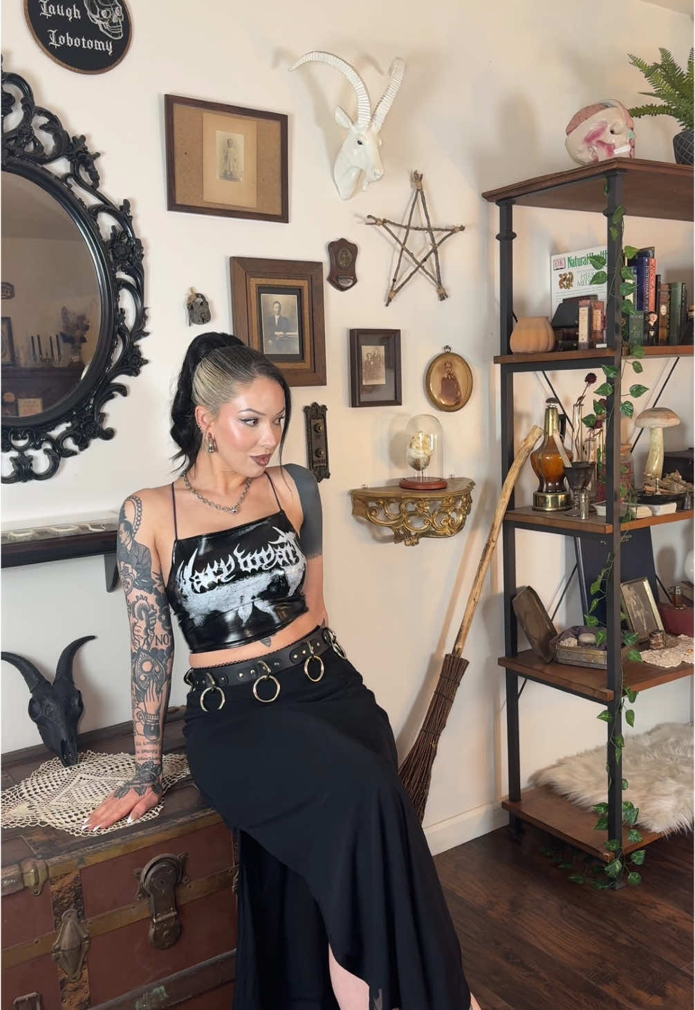 A post by @arachnisophia on TikTok caption: Forever haunting my home and admiring all my trinkets🔮 #maximalistlivingroom #altstyle #softalthair #altlook #gothfashionstyletips #whimsicalgothoutfits #gothfashioninspiration #gothstyle 