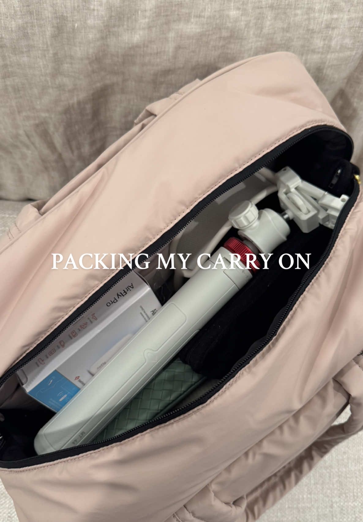 A post by @_catben_ on TikTok caption: Just a girl and her 47 lb carry-on ✈️#asmr #packwithme #travel #chicago #travemusthaves  #contentcreator #essentials #amazonfinds 