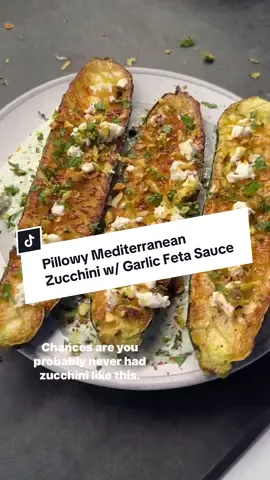 A post by @ketorecipes on TikTok caption: 🧄🍋 Pillowy Mediterranean Zucchini with Garlic Feta Sauce   You haven’t had zucchini like this. Soft, pillowy, and infused with so much flavor. 👇This is one of my fav recipes from my New York Times best selling cookbook… its on page 37, and if you dont have it, comment SHREDHAPPENS below and I’ll message you how to grab it! We’re talking the most amazing zucchini you’ve had with the best mediterranean vibes. You score the zucchini so it soaks up every drop of that creamy sauce. It’s served up with a sauce thats got garlic, feta, lemon, mint, and its topped with crushed pistachios and extra feta on top.  It’s so easy and so good. Here’s how to make it: 1.Rinse 2 medium zucchini and slice them in half lengthwise. 2.Use a sharp knife to score the cut side in a crosshatch pattern. 3.Sprinkle with salt and let sit for 20-30 mins to release moisture. Dab dry with a paper towel. 4.Preheat your oven to 450°F. 5.While the zucchini rests, make the garlic feta sauce. In a food processor, blend 3 tbsp Greek yogurt, 1 oz crumbled feta, 1 garlic clove, a handful of fresh mint, 1/4 cup lemon juice, the zest of a lemon, a couple pinches of salt and pepper. 6.Heat 4 tbsp avocado oil in a cast-iron or stainless pan over medium-high heat. Add zucchini cut-side down and sear for 4 to 5 minutes until golden. 7.Transfer the pan to the oven. Roast for 5 minutes, flip the zucchini, and roast another 5 minutes. 8.Spoon the sauce onto a plate, lay the zucchini on top (cut-side up), and finish with more crumbled feta, fresh chopped mint, crushed pistachios, lemon zest, and sumac. This is one of my FAVORITE recipes in my new cookbook. Comment SHREDHAPPENS and I’ll message you how to grab it!👇  #lowcarb #lowcarbrecipes #goodmoodfood #healthyrecipes #goodmoodfood #healthyfoodshare #keto #ketorecipes #mediterraneanfood