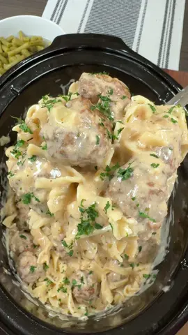 A post by @cookinginthemidwest on TikTok caption: Crockpot Swedish Meatballs are a great weeknight dinner!  Recipe 1 bag of frozen meatballs  10 oz can cream of mushroom soup 2 cups of beef broth  1 tbsp of Worcestershire sauce  1 tbsp Steak Sauce  1 tbsp Dijon mustard  1/2 tsp each of salt and pepper  1 tsp each of parsley flakes and onion powder  1 tbsp of minced garlic 1 onion, chopped  1/2 cup of sour cream  12 oz bag egg noddles  Steps Add one bag of frozen meatballs to a crockpot. Next, add cream of mushroom soup, beef broth, Worcestershire sauce, Steak sauce, and Dijon mustard.  Season everything with salt, pepper, parsley, onion powder, and minced garlic in a slow cooker. Add a small chopped onion and stir everything together well.  Cook on low for 4-6 hours. After 4-6 hours boil 12 oz of egg noddles according to the directions on the package.  Add sour cream and 12 oz of cooked egg noodles to the crockpot and stir well. Top with dried parsley. Enjoy!!  #easyrecipes #crockpot #meatballs #crockpotrecipe #swedishmeatballs 