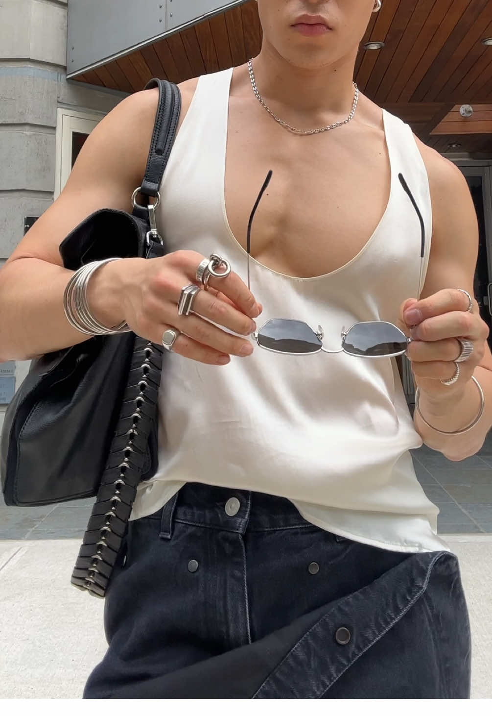 A post by @theedwardpark on TikTok caption: My favorite season is tank top season 😤 wearing my new @SAINT LAURENT bag and @le PÈRE jeans #fyp #fitcheck #tanktop 