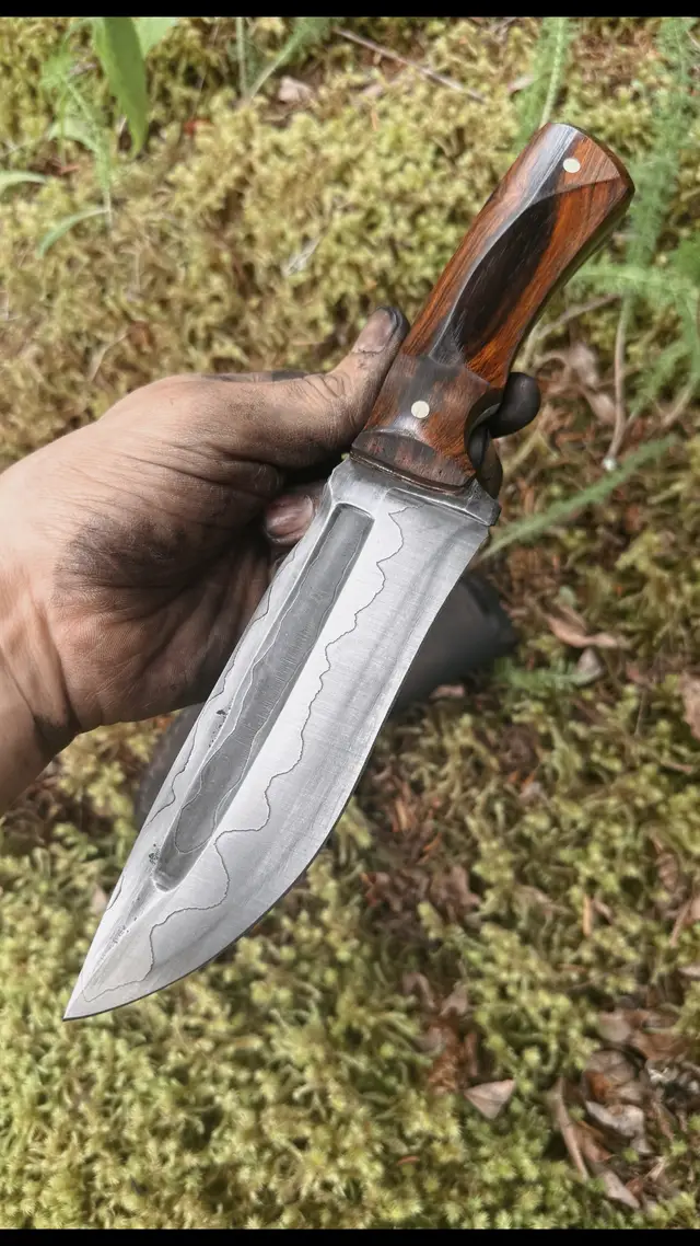 A post by @barrettknives on TikTok caption: SOLD Sanmai Hunter  1095 and 15n20 with Desert Ironwood and Teak Liners Plus Leather Sheath