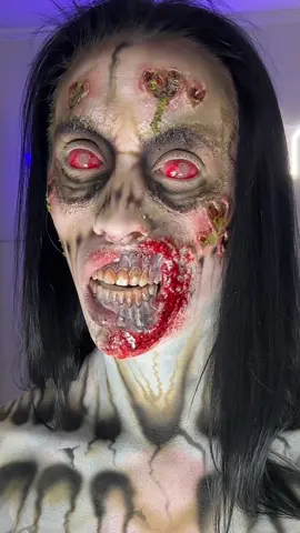 A post by @zombae.undead on TikTok caption: What? It’s just a flesh wound 😈 #sfx #horror #zombie #airbrush #prosthetic 