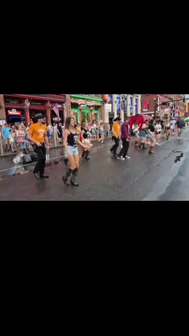 A post by @urbancowboylinedancing on TikTok caption: Footloose line dance  #nashville #cma2025 #urbancowboylinedancing #linedanceflashmob #wranglerjeans @Wrangler 