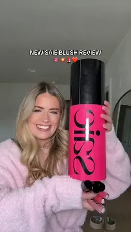 A post by @whitneyysimmons on TikTok caption: SHE’S BEING A LITTLE TOO FLIRTATIOUS 👄💄💥❤️ had to test out the new @Saie Dew Blush shades + matching lip oils ✨ #makeupreview #saieblush #blush #blushreview #makeupreview #newmakeup #grwm #makeuproutine 