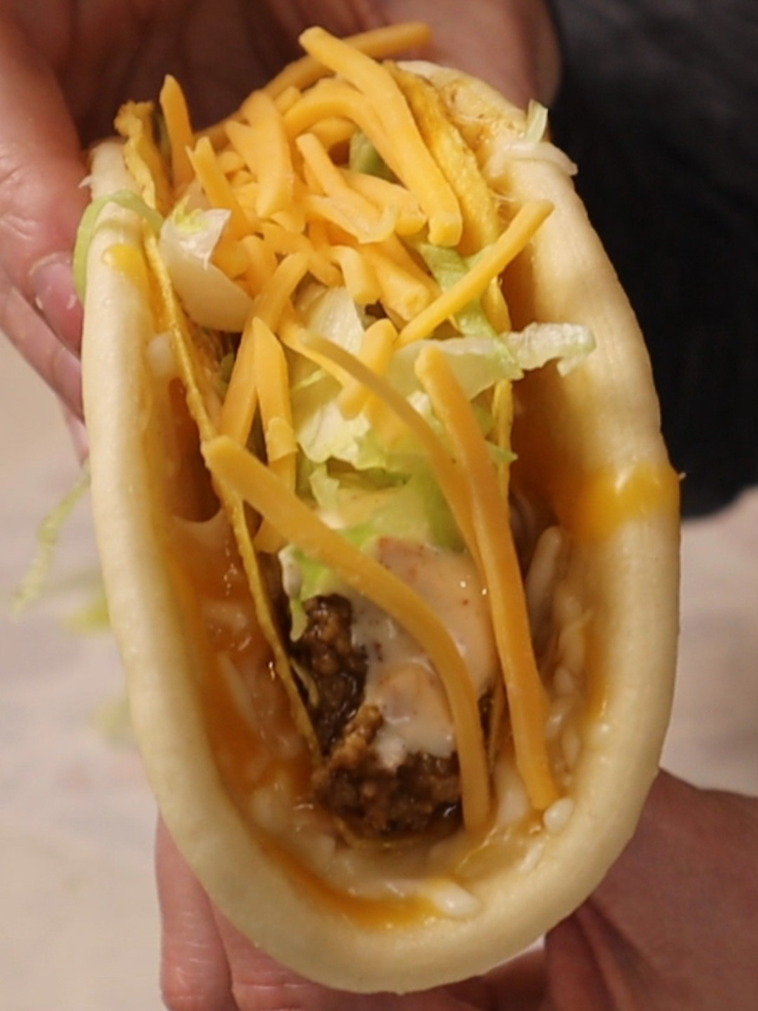A post by @dollartreedinners on TikTok caption: This is how I make a cheesy gordita crunch at home, and it’s pretty close to the real deal. Cheesy Gordita Crunch (Taco Bell Copycat) What you’ll need: • 1 flatbread (I used Mission brand chalupa shells and didn’t fry them) • Crunchy taco shell • Seasoned taco meat • Shredded lettuce • Baja sauce (recipe is in my previous video) • 3-cheese blend (cheddar, Monterey Jack, mozzarella — or use taco/Mexican blend) How to make it: Soften the flatbread in a dry pan for 10–15 seconds per side. Set up a simple steamer: add water to a large skillet, place a ceramic plate inside, and bring it to a boil. Add a handful of cheese to the flatbread, place it on the plate, cover with a lid, and steam until the cheese melts. Press a crunchy taco shell onto the melted cheese so it sticks. Fill the taco with seasoned meat, a generous drizzle of Baja sauce, shredded lettuce, and a small pinch of cheddar cheese. Wrap it in paper if you want the full Taco Bell effect. It takes a little more prep than a regular taco, but it’s worth it. #cheesygorditacrunch #tacobellcopycat #budgetcooking #easyrecipes #fromscratchrecipes #diytacobell #homemadetacobell #gorditacrunch #nostalgicfood #weeknightdinner #recreationrecipes #flatbreadtaco