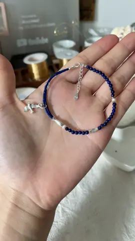 A post by @likayjewel_diylilylin on TikTok caption: Lapis lazuli bracelet with sterling silver fish and bird charms 🐟💕🐦‍⬛✨#handmadejewelry #tutorial #jewellery #bracelets #lapislazuli #blue #bracelet #braceletmaking #braceletstacks #ocean #shore #charmsbracelet 