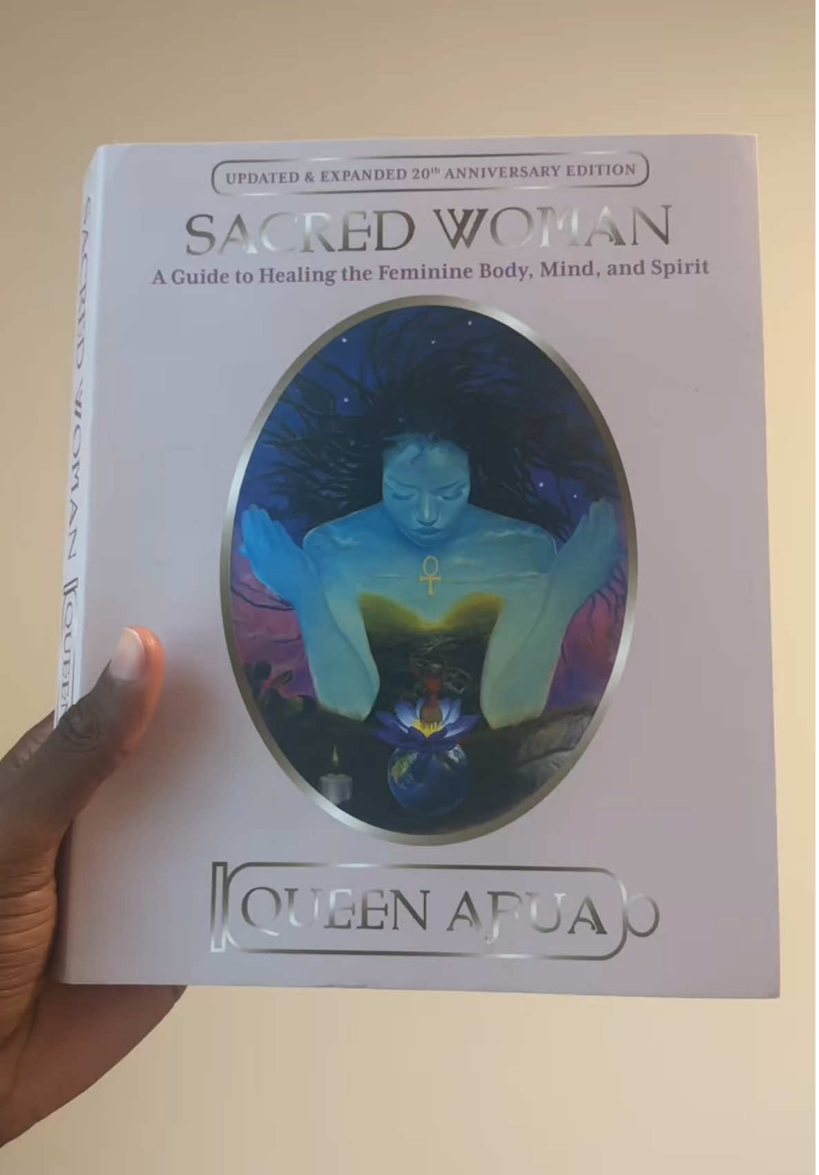 A post by @shaq_mair44 on TikTok caption: I started reading Sacred Woman by Queen Afua and it’s not just a book—it’s a spiritual awakening. It breaks down womb health, emotional trauma, self-care rituals, and the divine feminine. Every woman and every man who loves a woman should read this. #BookTok #SacredWoman #QueenAfua #HealingEnergy #DivineFeminine