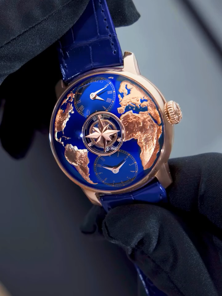 A post by @jacobandco on TikTok caption: Inspired by the world and crafted with emotion, The World Is Yours Dual Time Zone Tourbillon is a tribute to Jacob Arabo’s first timepiece, gifted by his father. The World Is Yours Dual Time Zone Tourbillon features a 30-second floating tourbillon, sapphire bridge, and a world map dial that pays tribute to a father’s gift—turning history into high horology. 43-mm rose gold case 30-second central tourbillon Two independent time zones Self-winding movement with micro-rotor #inspiredbytheimpossible #JacobAndCo