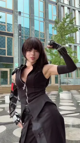 A post by @teacakecos on TikTok caption: rain interrupted our shoot, but as you can tell, it was also just a ✨little✨ wimdy 😂 #finalfantasy7 #tifalockhart #tifacosplay #ffviiremake #ffvii #cloudstrife #germancosplay 