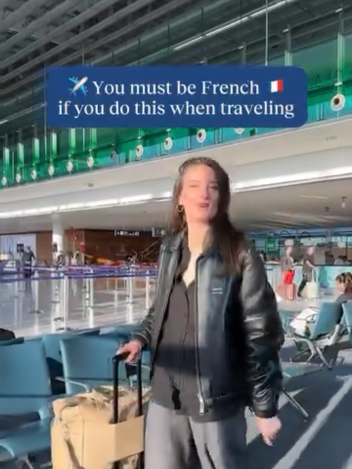 A post by @hellofrenchnyc on TikTok caption: How to know you’re French when traveling 🇫🇷✈️ You might be a French traveler if:  – You complain… even when the flight’s on time 😒  – Champagne? Immediately. 🥂  – Extra bread + butter, s’il vous plaît 🥖  – French movie + wine combo 🎥🍷 – No leggings on a plane 🚫 Planning to travel to Paris soon? Grab my guide full of my fave recs in the link in bio!