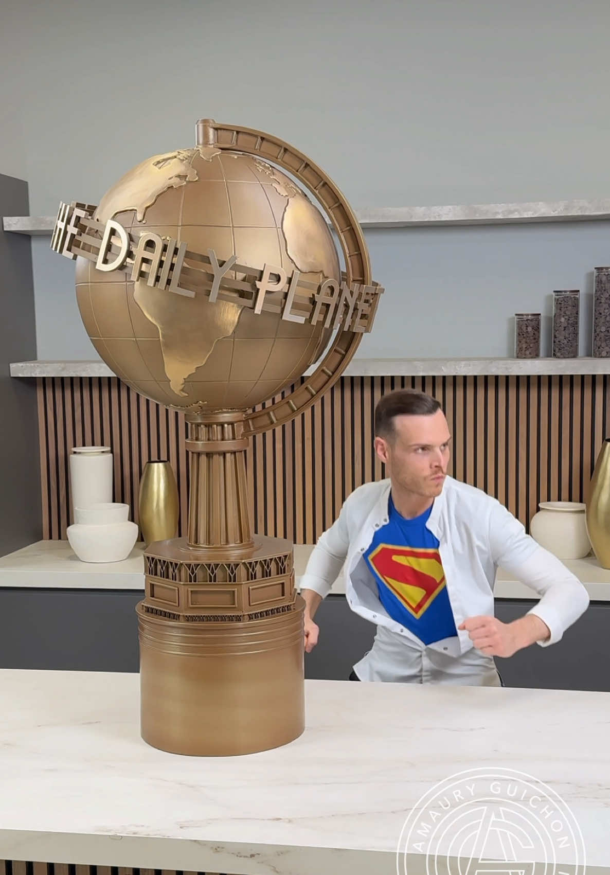 A post by @amauryguichon on TikTok caption: #WBPartner I am honored to have been challenged by @Warner Bros. to recreate the iconic Daily Planet Globe from the upcoming @Superman movie arriving in theaters July 11th. For the occasion, let’s awaken the Superhero in all of us! Tickets on sale now. #amauryguichon #chocolate #superman @DC 
