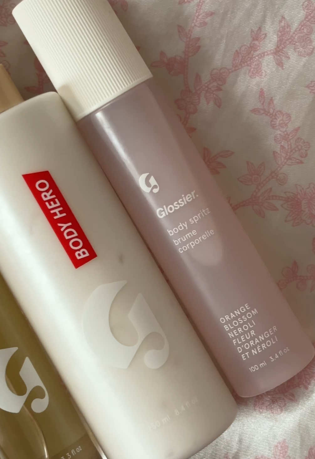 A post by @camrihewie on TikTok caption: Here's how I like to layer my @Glossier body products featuring the new Orange Blossom Neroli Body Spritz! 🧴🧖🏾‍♀️ #glossierpartner