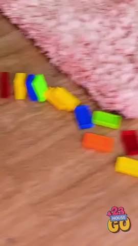 A post by @123gohouse on TikTok caption: This tiny gadget will change how you setup dominoes #funnyvideos #kidsoftiktok #toy #funn #creative 