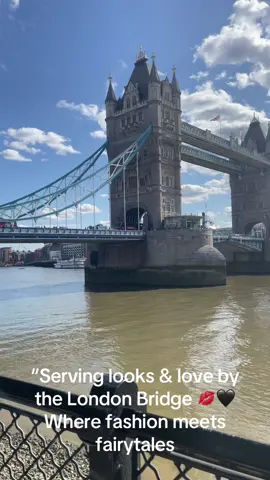 A post by @elu_38 on TikTok caption: “Serving looks & love by the London Bridge 💋🖤 Where fashion meets fairytales 🇬🇧✨ #LondonLove #StyleInTheCity #RomanticGetaway #OOTD #CoupleGoals #FYP”