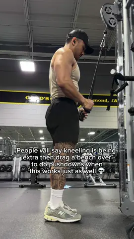 A post by @jpgcoaching on TikTok caption: Doing pushdowns on a bench is valid and it does help with bracing but I find it funny that I often get comments about kneeling during my pushdowns considering how easy it is to do in comparison.  I do it because the attachment is long and I can’t stand close to the cable while using a full rom. I want to stand closer so the cable stays mostly vertical and isn’t pulling me forward. Doing so lessens my need to brace and I don’t need to drag a bench over which is a big plus. #triceps #armworkout For personalized 1:1 coaching apply on my site  For $1 a day science based 3-4 day programs you can find them in the same place! Supps- @Legion Supplements JPGCOACHING