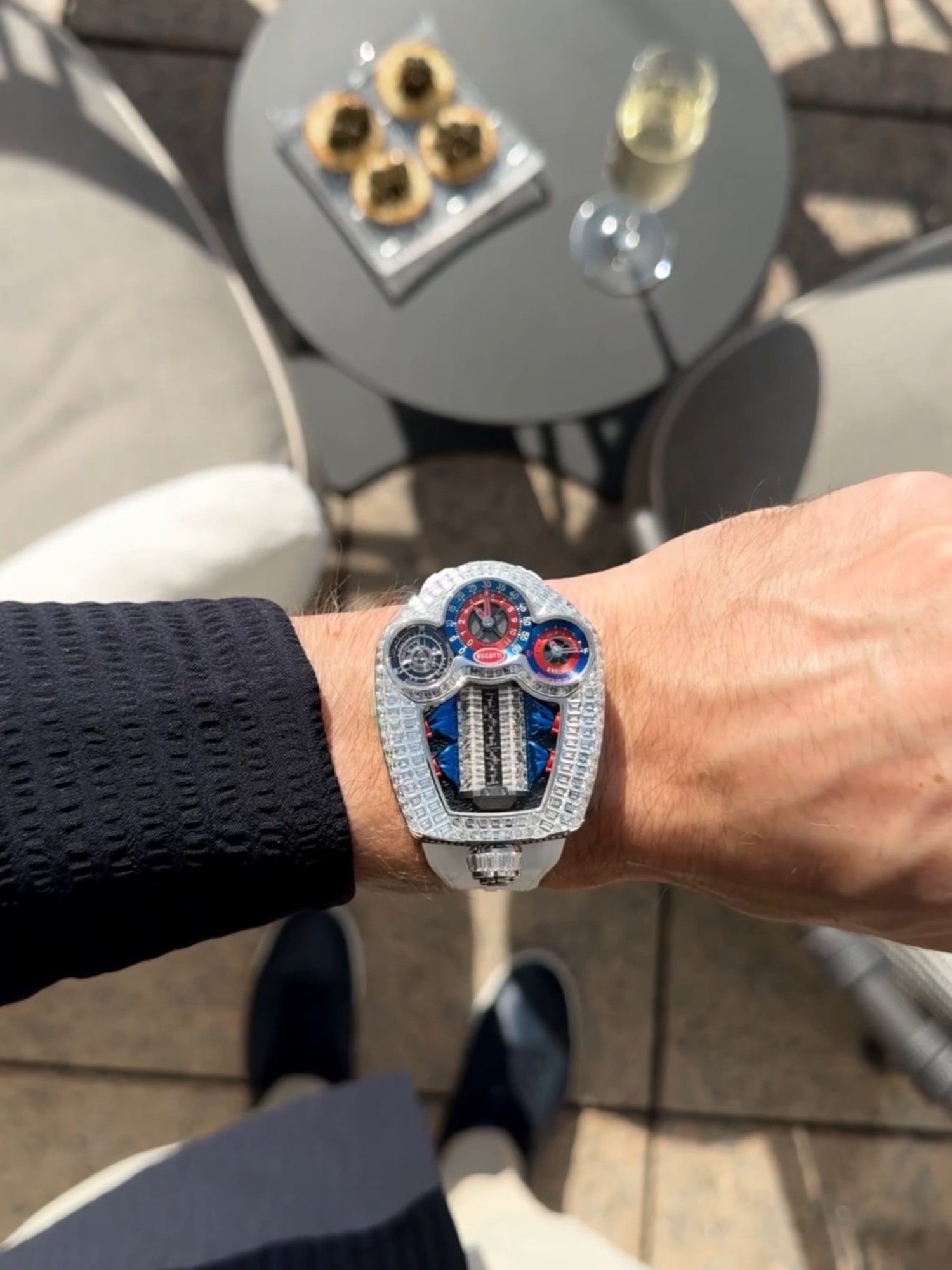 A post by @jacobandco on TikTok caption: A tourbillon built like a supercar — and iced out in baguette diamonds. Start your engines.  #BugattiTourbillon #JacobAndCo