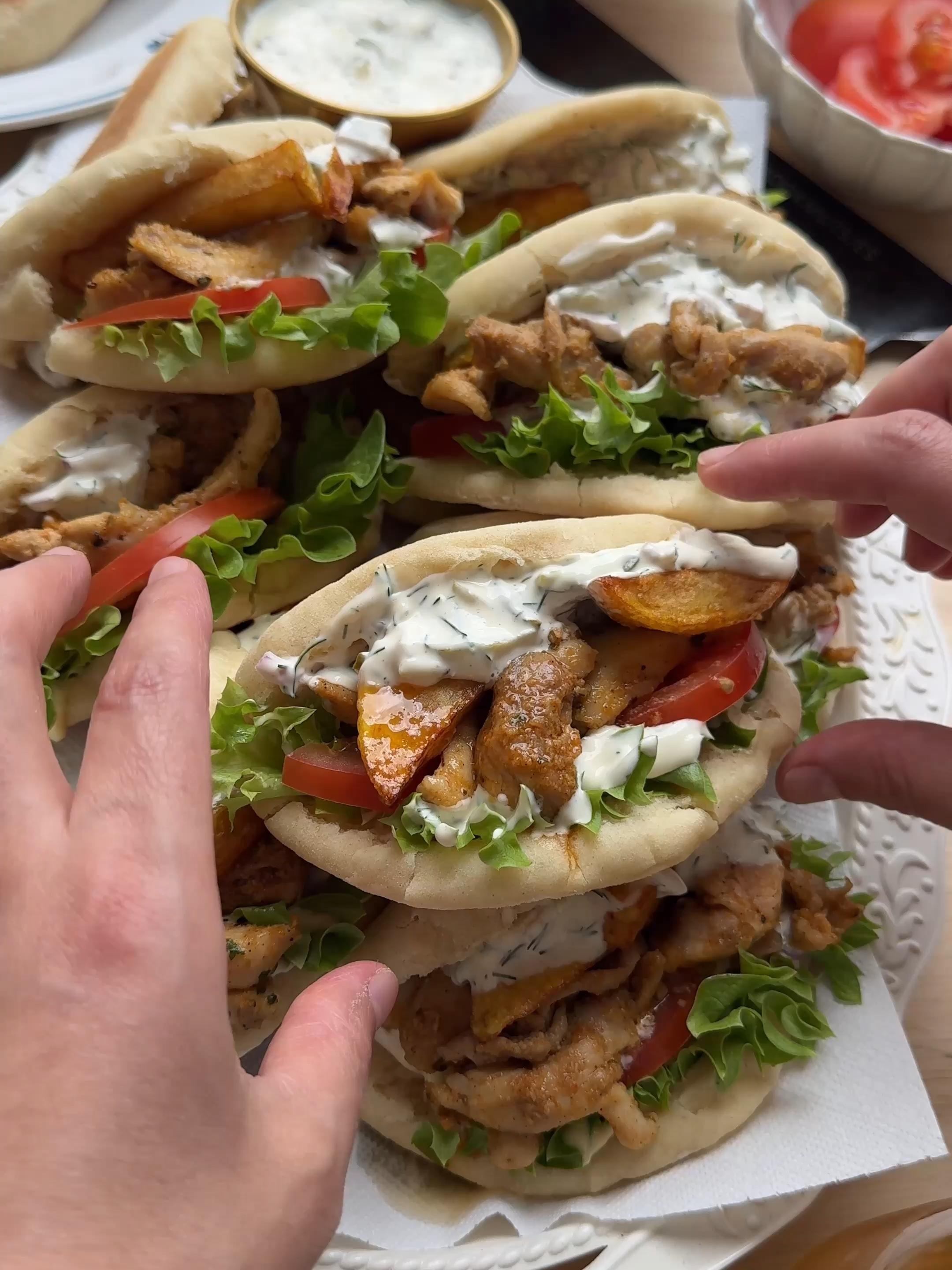 A post by @kookmutsjes on TikTok caption: BREAD CHICKEN GYROS #food #recipe #bread #Greek #chicken #Gyros #fyp #foryou DOUGH 200 ml lukewarm water 10 g instant yeast 25 g honey 100 g Greek yogurt 30 ml olive oil 500 g flour (all-purpose flour) 9 g salt (1½ teaspoons) CHICKEN MIXTURE 800 g chicken thighs 5 g salt (⅚ teaspoon) 3 g garlic powder (1 teaspoon) 3 g onion powder (1 teaspoon) 2 g black pepper (⅔ teaspoon) 1 g dried oregano 20 ml lemon juice 25 g mustard 25 ml olive oil 30 g unsalted butter SAUCE 150 g mayonnaise 100 g Greek yogurt 60 g pickles 5 g dill 15 g red onion 1 g black pepper (⅓ teaspoon) EXTRA fries Mix the lukewarm water, yeast, and honey in a bowl. Let it sit for 5 minutes. Add the Greek yogurt and olive oil and mix together. Then add the flour and salt. Knead for 10–12 minutes until smooth. Cover the dough and let it rise for 1 hour in a warm spot or until doubled in size. Wash and cut the chicken thighs into pieces. Place them in a bowl and add the salt, garlic powder, onion powder, black pepper, oregano, lemon juice, mustard, and olive oil. Mix well. Deflate the dough and divide it into 14 equal pieces of about 60 grams each. Shape into balls. Roll each ball out into a flat oval of about 15 × 13 cm. Fold the dough in half. Place the dough on a baking tray lined with parchment paper. Let it rise for 30 minutes, or until doubled in size. Cook the bread in a skillet with a thick bottom until golden brown on both sides over medium-low heat.  Immediately cover the bread with a clean kitchen towel to keep them soft and fluffy. Heat the butter in a skillet and cook the chicken until done. Make the sauce by mixing the mayonnaise, Greek yogurt, chopped pickles, dill, red onion, and black pepper. Slice open the bread and fill with the sauce, cooked chicken, and fries. Enjoy, bismillah!