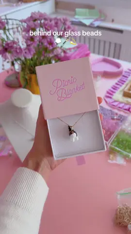 A post by @picnicblanketjewellery on TikTok caption: Another dreamy day at Picnic Blanket💭💓✨  #lampwork #glassstudio #picnicblanketjewellery #glassjewellery 
