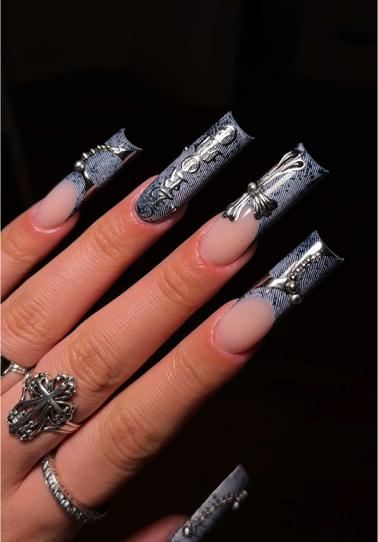 A post by @sulysnailography on TikTok caption: Inspo by: @Vanki Nails 🩶 just added a few slight changes. I am obsessed didn’t want to take these off! #denimnails #jeannails #denimnailart #chromehearts #chromeheartsnails #nailsoftiktok #longnails #nailinspo #nailideas #metalnails #acrylicnails #fyp #bluenails #3dnailart #nailarttutorial #bluejeans #nailtutorial 