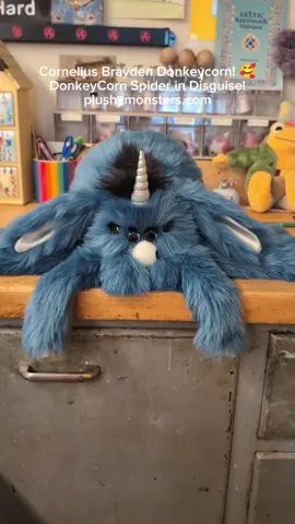 A post by @plushymonsters on TikTok caption: CORNELIUS BRAYDEN DONKEYCORN!!! 🥰🥰🥰 This Lil' Guy is so soft and grumpy and wonderful. 🥰🥰🥰 He will be available on our super weirdly timed Thursday Hatching Day, June 26th, 2025, 5:00 p.m. MDT at plushymonsters.com! 😁 He will be $220.00 plus shipping. Hurrah! 😁 #plushymonsters #hatchingday #spidersindisguise 
