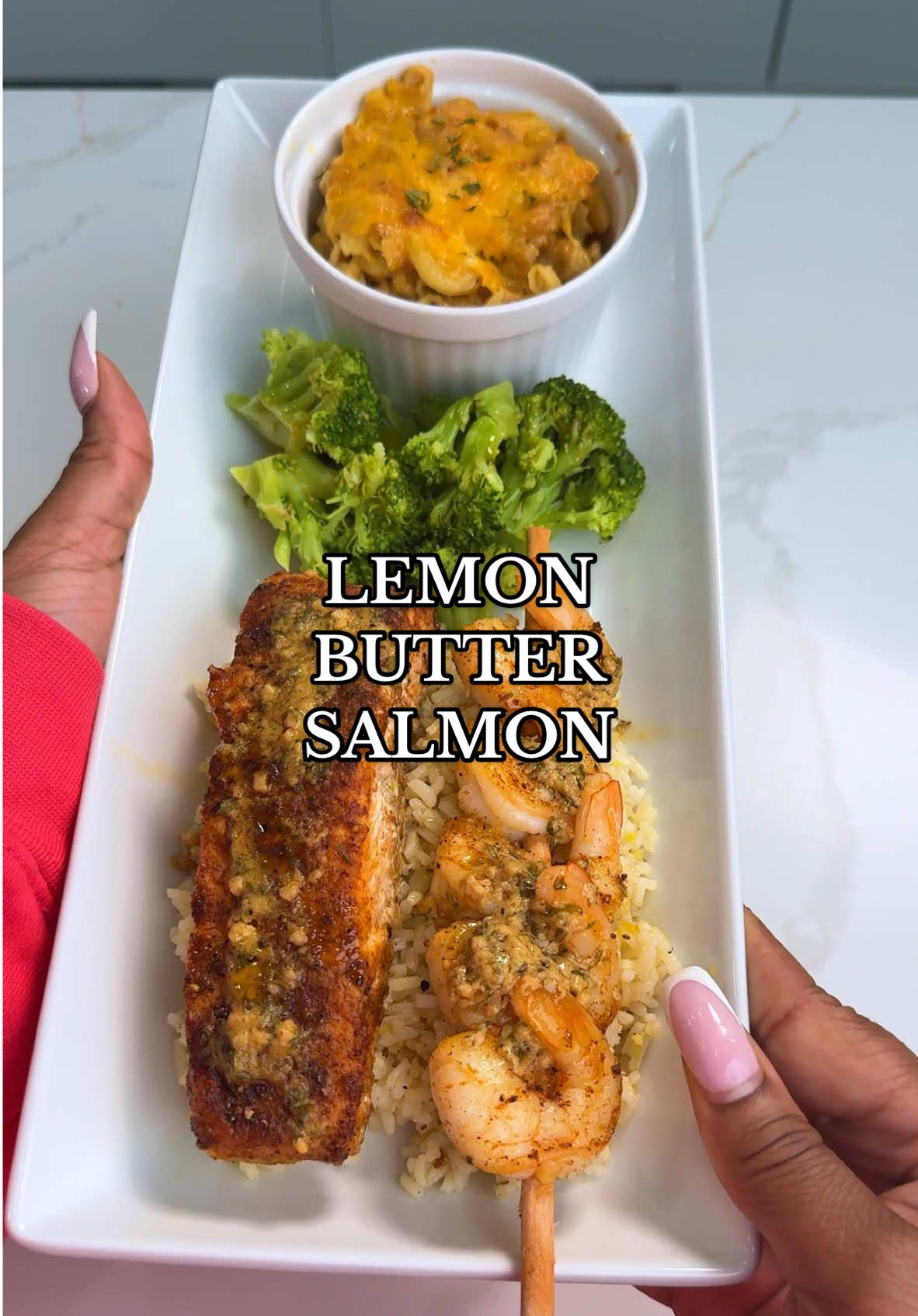 A post by @summerreignhenning on TikTok caption: Make dinner with me! Salmon in a lemon butter cream sauce, grilled shrimp skewers, rice, broccoli and baked mac & cheese 😋