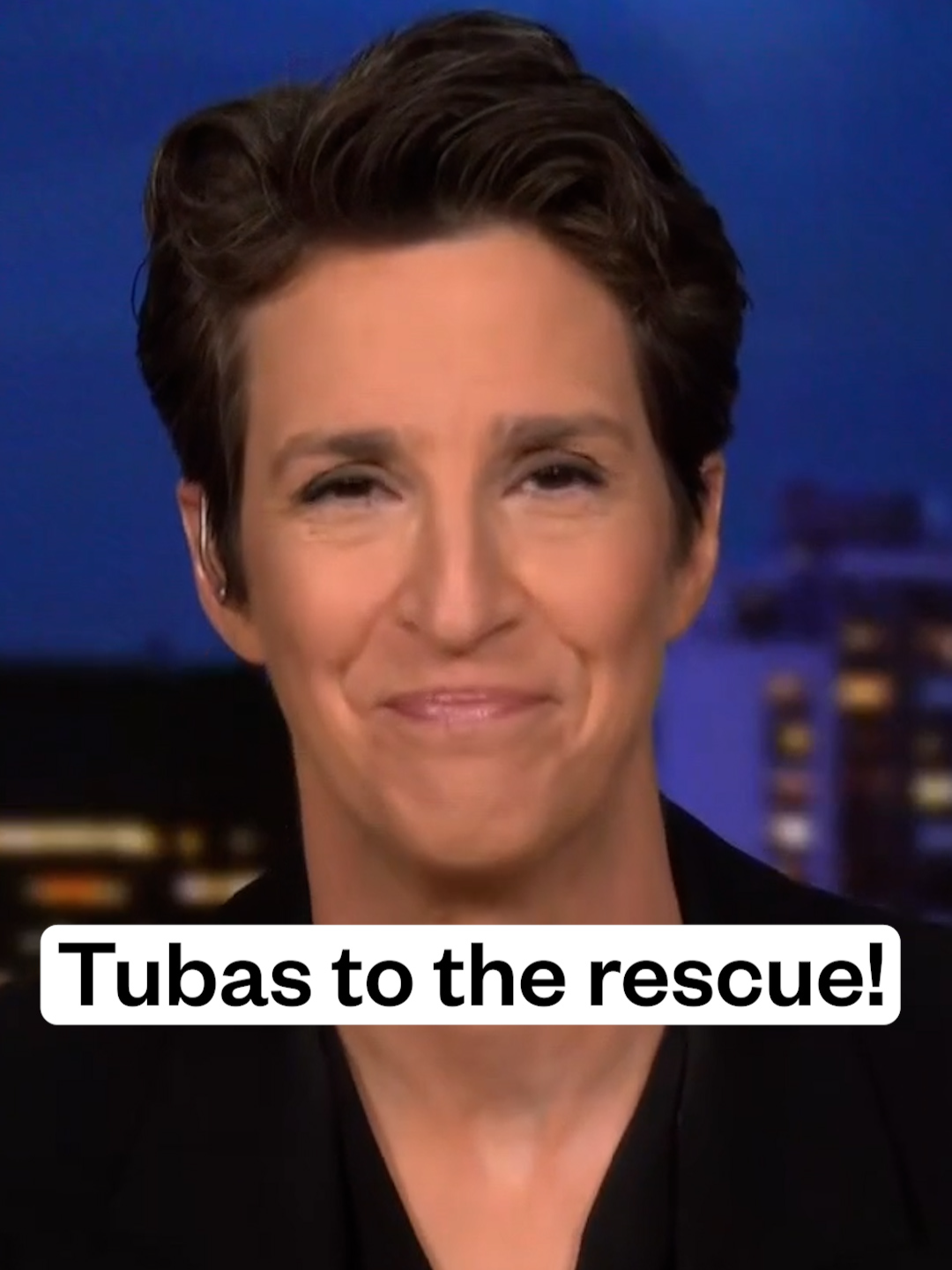 A post by @maddowshow on TikTok caption: Rachel Maddow celebrates the power of music to make a statement peacefully but no less loud and clear. When members of the Proud Boys tried to agitate during Atlanta's No Kings protest, a tuba came to the rescue. Watch more clips of the Rachel Maddow Show on YouTube at MSNBC.com/Rachel #fyp #news #politics #trump #activism #protest #nokings #horns @msnbc
