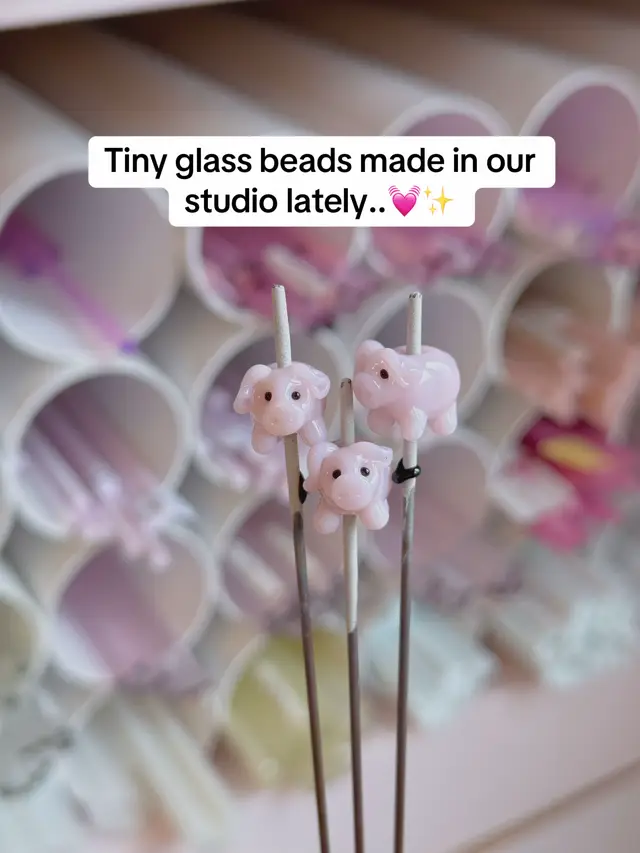 A post by @picnicblanketjewellery on TikTok caption: Here’s a closer look at just a few of the adorable charms made in our studio over the last few days! Which one is your favourite? Let us know in the comments!💓🐷🐿️🔥💫✨ #lampwork #picnicblanketjewellery #glassart #glassjewellery 