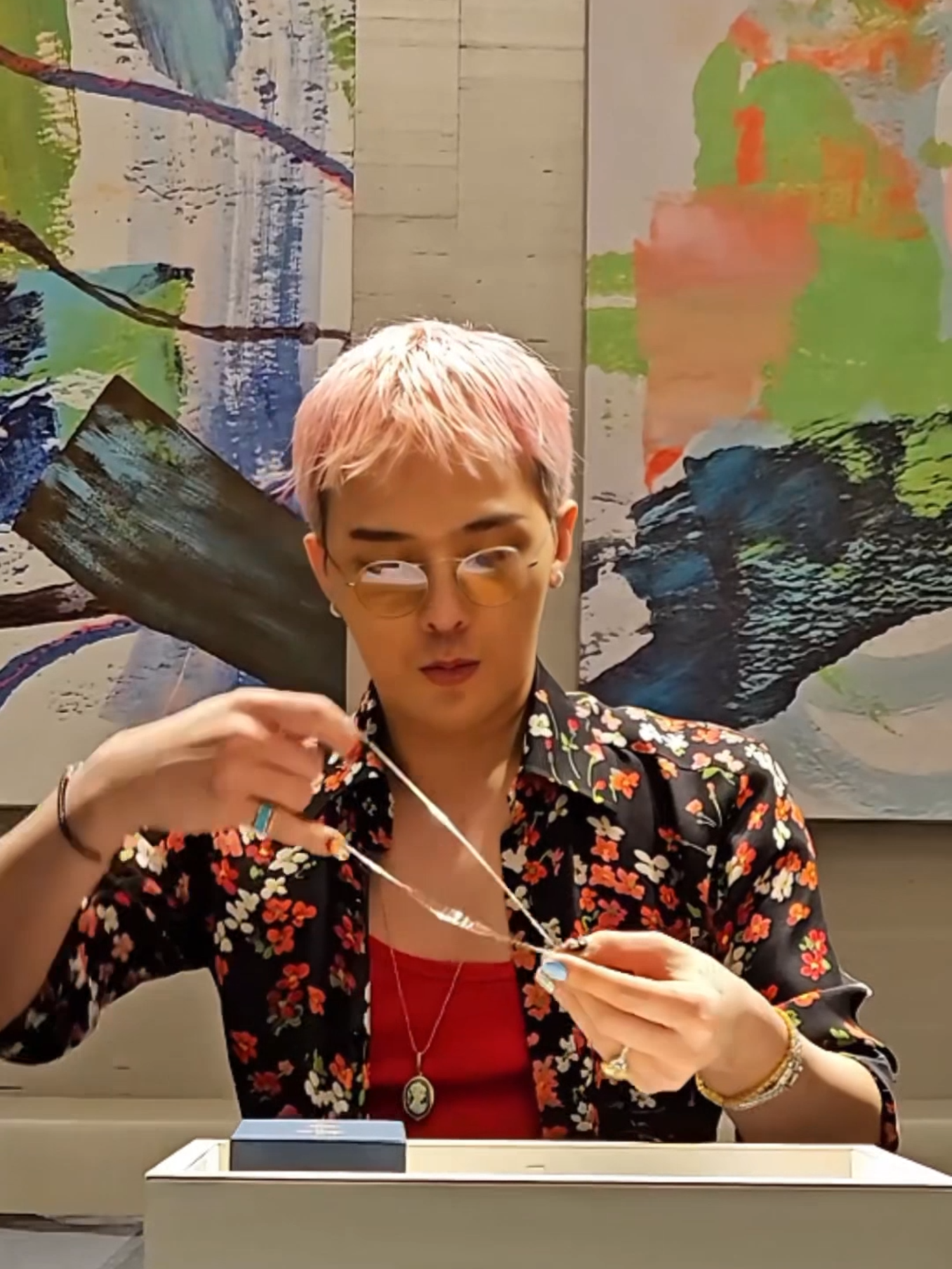 A post by @jacobandco on TikTok caption: The daisy has been with G-DRAGON for years — in his lyrics, his visuals, his clothes, even his skin. But it’s never been perfect. One petal is always missing. This pendant was born from that idea. G-Dragon came to us with a vision — to turn his most personal symbol into something his fans could carry with them. We handled the build. He shaped the message. Jacob & Co. x PEACEMINUSONE is now available in 925 Silver and 18K White Gold. Limited release. #JacobAndCo #PEACEMINUSONE #GDRAGON #InspiredByTheImpossible