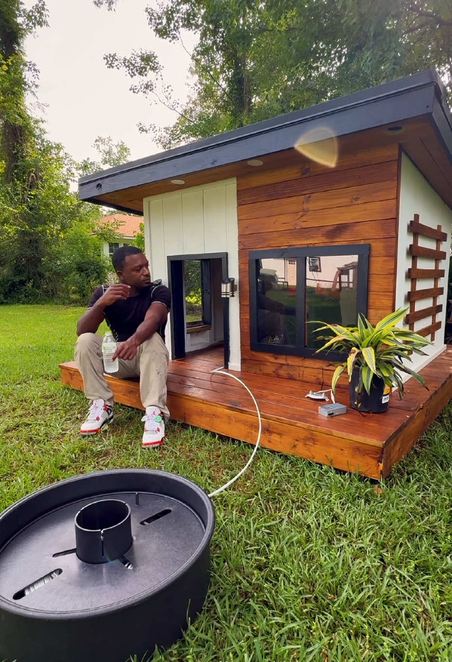 A post by @unclejhonn on TikTok caption: My Neighbor called for a doghouse and I gave them a doghouse. I also partnered with @Angi (Formerly Angie’s List) on this project and we went over the top. #Angi #AngiHouseCalls #unclejhonn