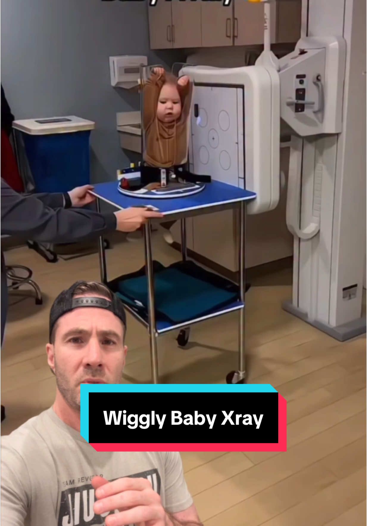A post by @drjoe_md on TikTok caption: This might look like a torture device or the start of a magic trick, but it’s actually a Pigg-O-Stat—a pediatric X-ray immobilizer. It holds babies still so we can get a clear image without retakes or extra radiation. And no, we’re not about to saw anyone in half… unless the magician’s running late. 🪄🪚 #newbaby #newparents #babies #medical 