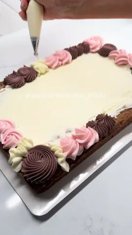 A post by @mainstreetsweets_frisco on TikTok caption: wait until the end to see the whole order with the cake pops 🤩💕 #cookiecake #buttercream #pipingbuttercream #fyp #foryou