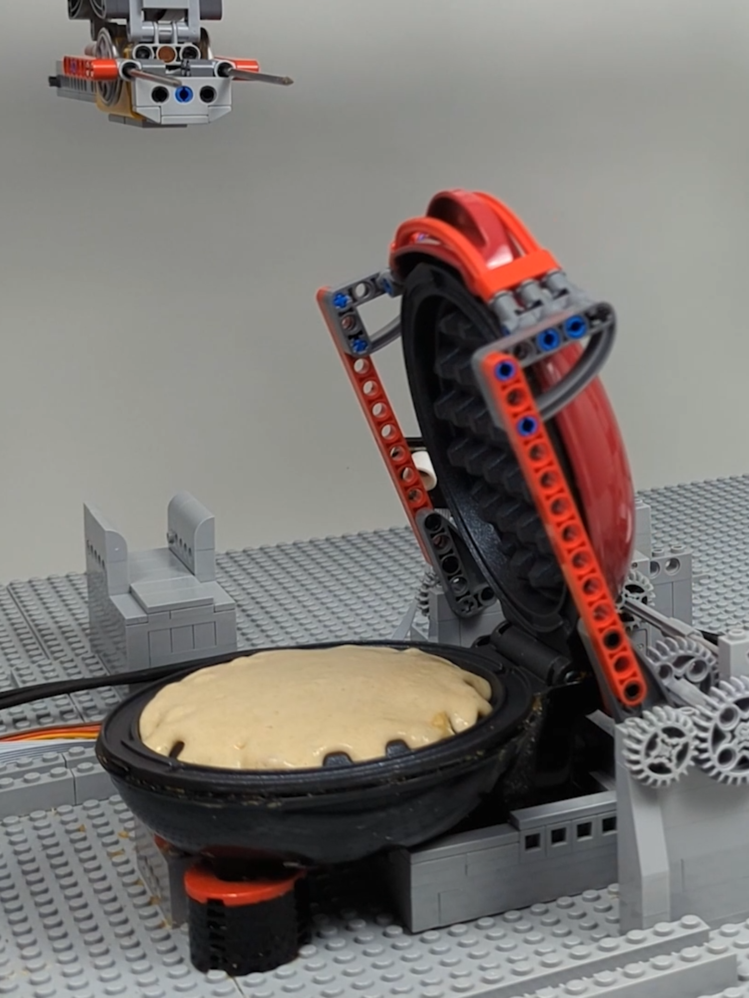 A post by @beyondthebrick on TikTok caption: Building a LEGO Waffle Factory! Created by Brick Machines #lego