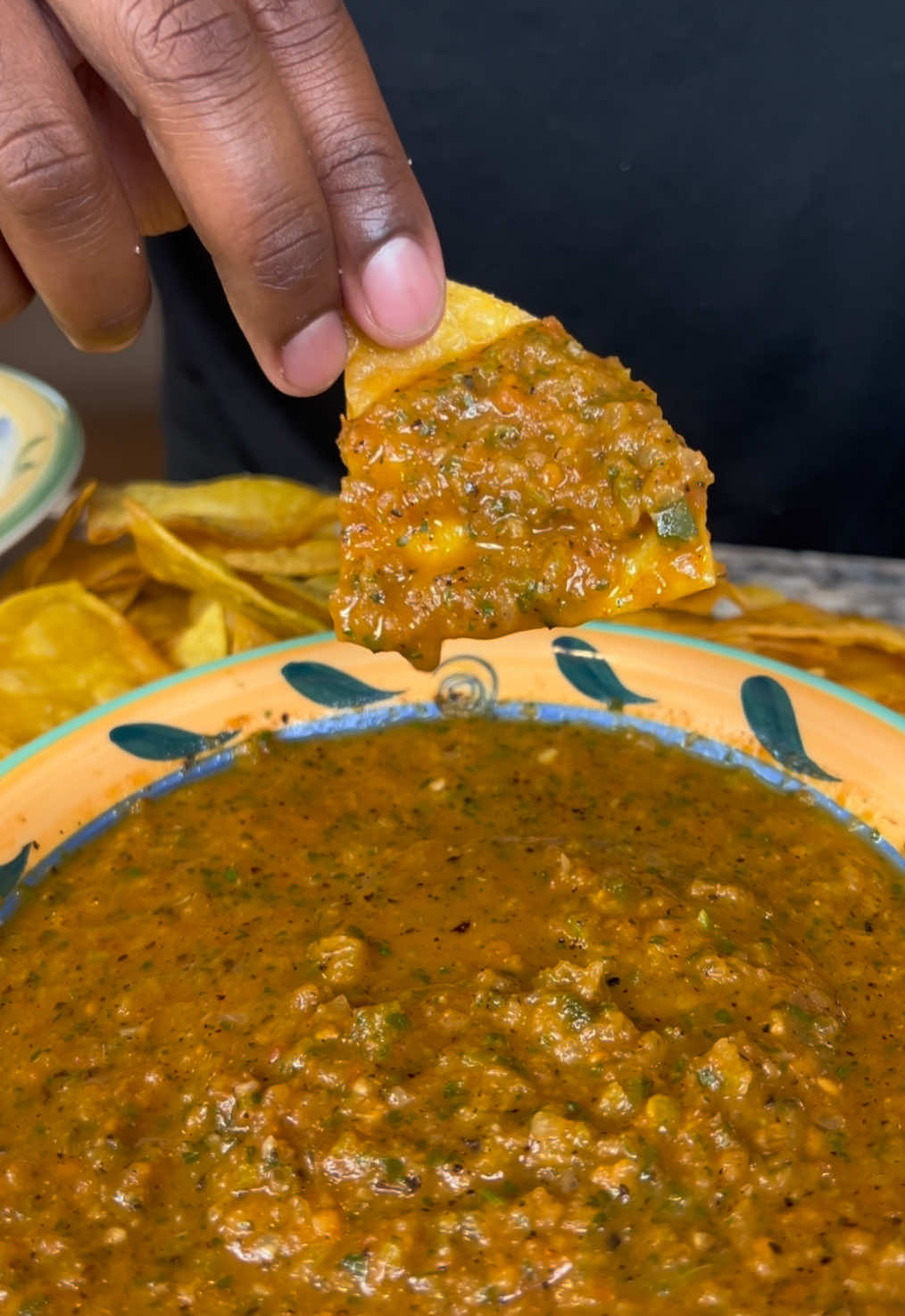A post by @eatwitzo on TikTok caption: Restaurant style Salsa and Queso!  There is nothing like a fresh bowl of salsa or queso and chips at the restaurant! Now you can make as much as you’d like at home! Enjoy!  Full Ingredient list:  For salsa:  5 roma tomatoes  2 jalapeños  1 large poblano pepper 1 onion quartered  3 garlic cloves  1/2 cup cilantro  1-2 limes juiced  1-2 tsp chicken bouillon powder  1-2 tsp cumin  1-2 tsp black pepper  1-2 tsp salt (optional)  Cayenne pepper to taste (optional)  For queso:  16-24 oz evaporated milk  12-16 oz white american/pepper jack cheese slices  1/4-1/2 cup diced hatch green chiles  #salsa #queso #eatwitzo 