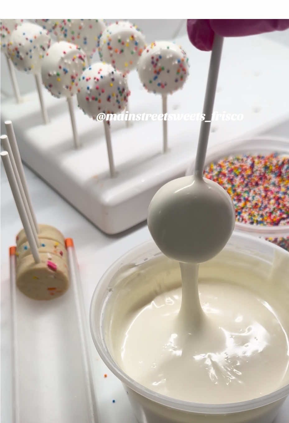 A post by @mainstreetsweets_frisco on TikTok caption: taking a page out of Amy’s (owner of @Daisy Makes) book lately & carrying around cake pops with me each week!!! I’ve loved passing these out while I’m out & about so if you see me with my tote, come say hi!! I probably have some pops for ya! #cakepops #cakepopprep #cakepopdough #minicakepops #fyp #foryou 