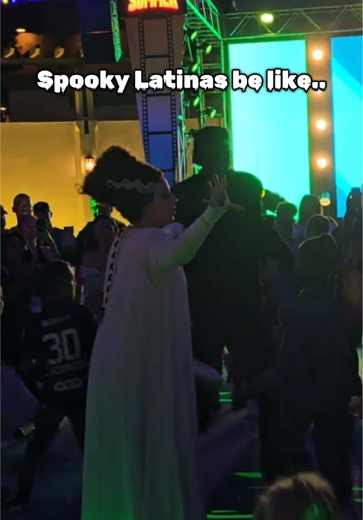 A post by @backstitchbruja on TikTok caption: Happy Summerween 🎃 I need to make another trip to Universal Studios 🤭 original video from @kimmykimmkim @Universal Destinations @universalmonsters #brideoffrankenstein #megamoviesummer #beetlejuice #horrormovies #spookylatina 