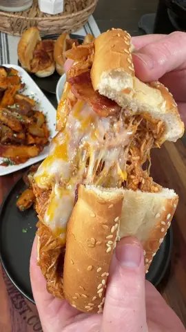 A post by @cookinginthemidwest on TikTok caption: Crockpot Shredded BBQ Chicken Sandwiches are an easy dinner recipe!  INGREDIENTS 1 lb chicken breasts 1 chopped red onion  1 tsp each of salt, pepper, paprika 1 tbsp ranch dressing seasoning 1 tbsp minced garlic 1 tbsp white vinegar BBQ Sauce (I used Buffalo Wild Wing’s Honey BBQ)  Buns/hoagie rolls  Colby Jack cheese slices  Bacon  INSTRUCTIONS  Spray a crockpot with cooking spray. Chop a red onion. Add the chicken, onion, minced garlic, vinegar, and all of the seasonings to a crockpot.  Add some BBQ sauce on top. I don't use exact measurements for this part. I usually just do enough to cover the chicken, but you can really use as much as you'd like. Cook on low for 4-6 hours. Shred the chicken, stir well, and add a little bit more BBQ sauce if needed. Toast the buns/hoagie rolls in a skillet over medium heat. Build sandwiches with the bbq chicken, bacon, and cheese. Enjoy! Let me know if you try it out!  #crockpot #bbqchicken #dinner #recipe #mealideas #easydinner #sandwiches 