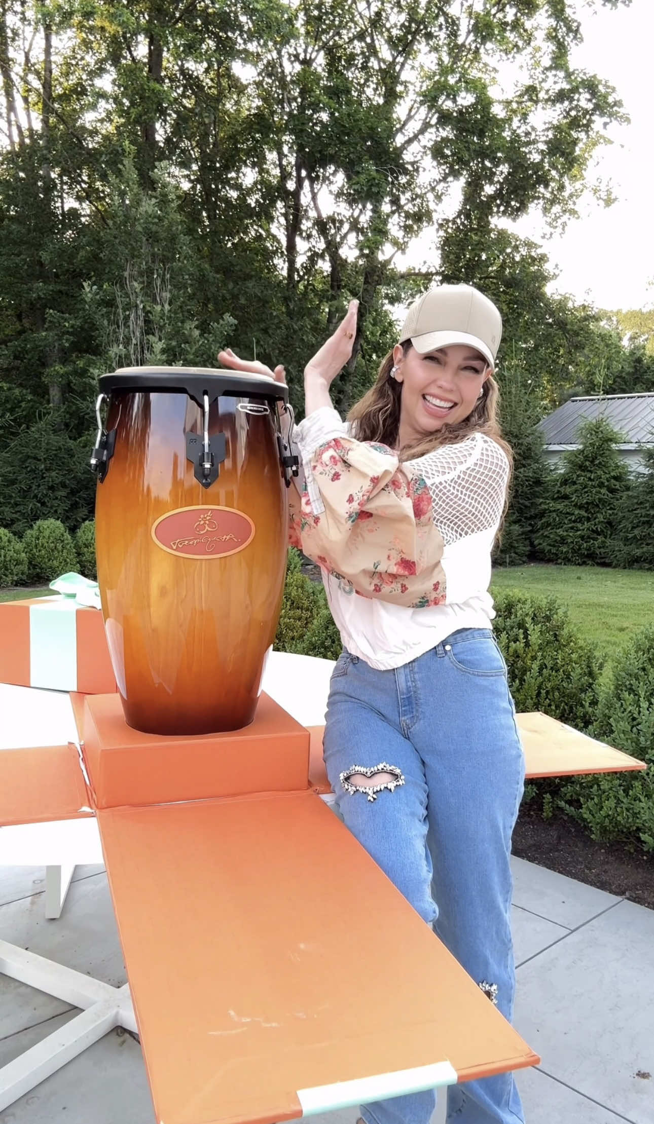 A post by @thalia on TikTok caption: Gracias TROPICOQUETA @Karol G por este regalo tan hermoso 🧡🪇🪘✨ me encantaaaa 