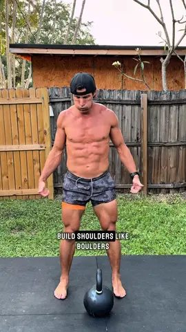 A post by @asgooch on TikTok caption: Build boulder shoulders with kettlebells. Link in bio for App & Programs. ✅  #shoulders #shoulder #shoulderworkout #upperbody #upperbodystrength #homeworkout 