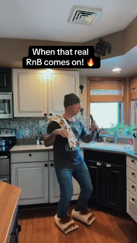 A post by @kevin.lawson on TikTok caption: The spaghetti spoon mic, taco towel, and Walmart slippers are BACK for another sold-out kitchen concert featuring Zapp! 😂🔥🎤 #rnb 