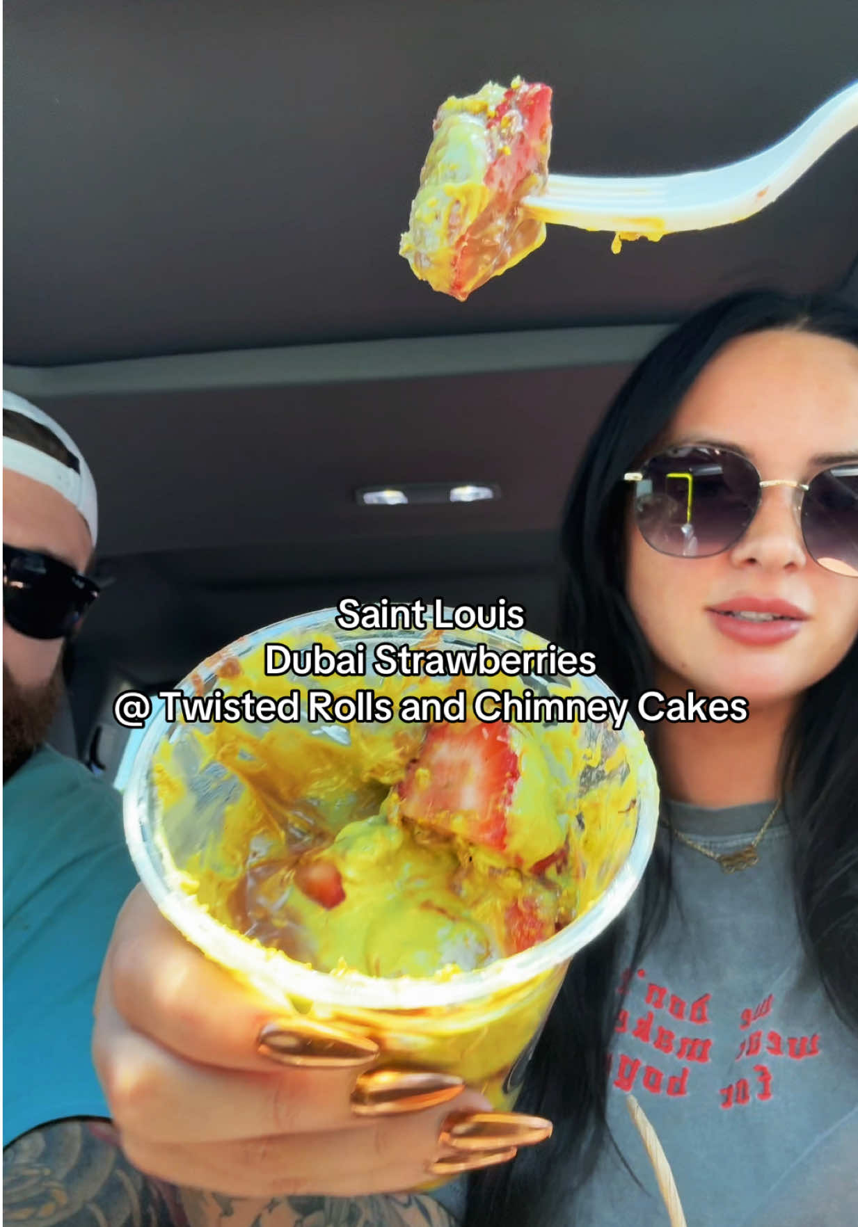 A post by @noelleglammua_ on TikTok caption: The pistachio cream on my fingernail is sending me 🙃 @Twisted Rolls Chimney Cake #dubaichocolate #dubaichocolatestrawberries 