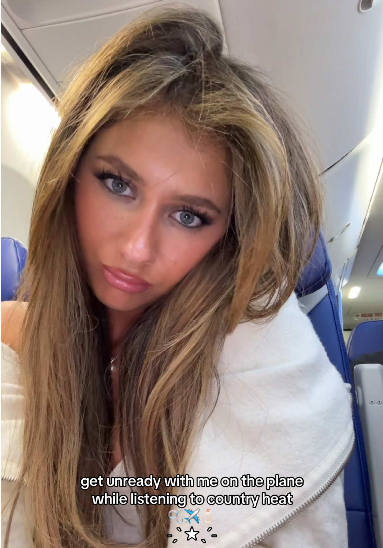 A post by @ellianawalmsley on TikTok caption: GUESS WHERE I AM OFF TO 😁😁😍 @Amazon Music #fyp #foryou #SkinCare #airplane #grwm #getunreadywithme #planeskincare #countryheatweekly #dasha 