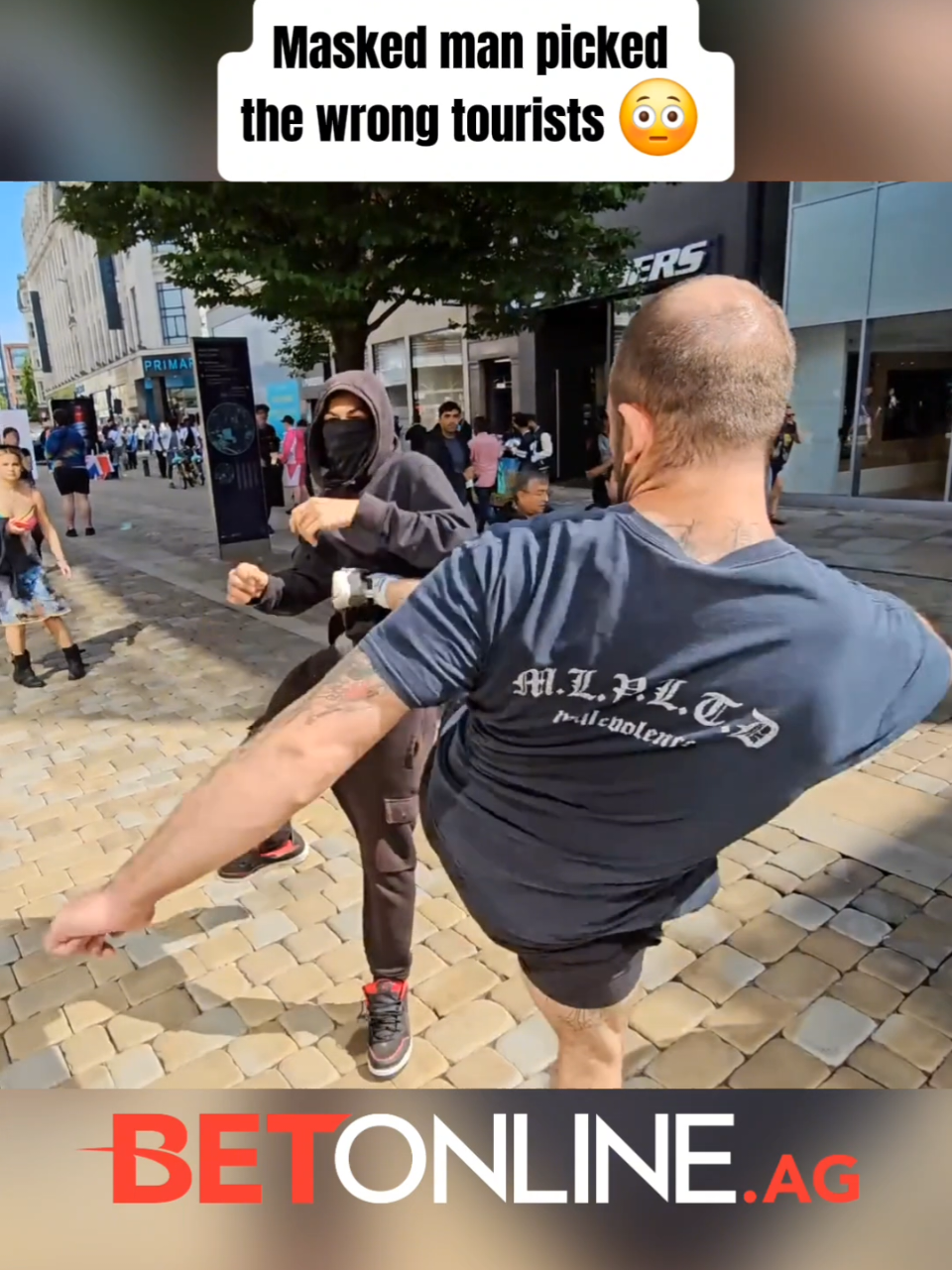 A post by @mma_mixup on TikTok caption: Masked man picked the wrong tourists 😳 #SelfDefense #travelfails 