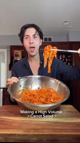 A post by @benjixavier on TikTok caption: High Volume, Low Calorie Carrot Salad 🥕🔥 This salad is so customizable. Add as much of everything as you like. Taste as you go. It’s your kitchen… your rules. 😎👨‍🍳👩‍🍳 Ingredients: 	•	🥕 Carrots – the crunchy, sweet base 	•	🌱 Green onions – for a fresh bite 	•	🧄 Garlic powder – flavor boost! 	•	🌶️ Chili crisp oil – spicy, savory, and addictive 	•	🥄 Sesame oil – just a touch for that nutty richness 	•	🍚 Rice vinegar – bright, tangy balance 	•	🧂 Low sodium soy sauce – umami without the salt overload 	•	🍯 Honey – a hint of sweetness 	•	⚪ Sesame seeds – for a finishing crunch Toss it all together and let it sit for a few minutes so the flavors can mingle. Serve chilled or at room temp. Perfect for meal prep, snacking, or pairing with your favorite protein. 💪🍽️