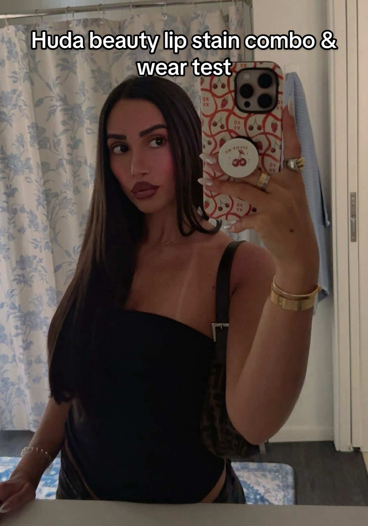 A post by @lebaneseangel22 on TikTok caption: @Huda Beauty lip stain wear test. I went to a grad party & family cookout, ate and drank all day (no straws!) and it was 90 degrees 85% humidity. This formula is gold 🧎‍♀️‍➡️