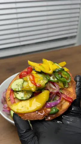 A post by @chefchosen on TikTok caption: Fresh mango & cucumber salsa that works on fish, tacos, vegan plates—whatever you’re working with. Spicy, tangy, and brings balance to anything you pair it with. What I used: 	•	1 cucumber 	•	1 large mango (or 2 small) 	•	1/2 red onion 	•	1 jalapeño 	•	1 red bell pepper 	•	1 yellow bell pepper 	•	Freshly chopped cilantro Full detailed recipe will be added to my e-cookbook by the end of this week.