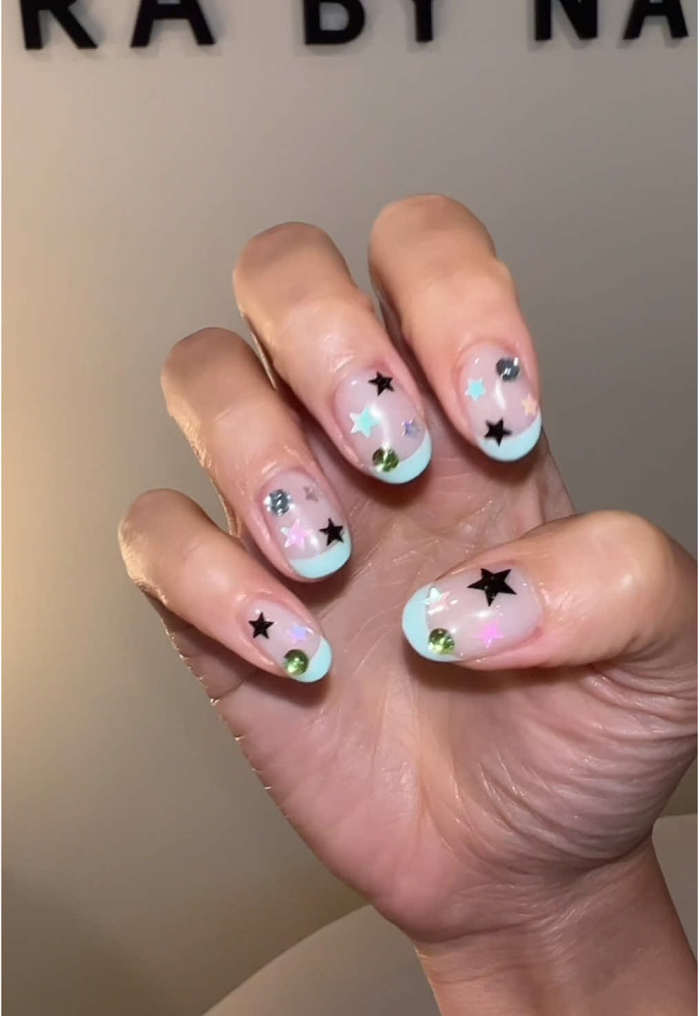 A post by @ on TikTok caption: Come with me to get my nails done @Amirabynaomi 📍Bangkok 