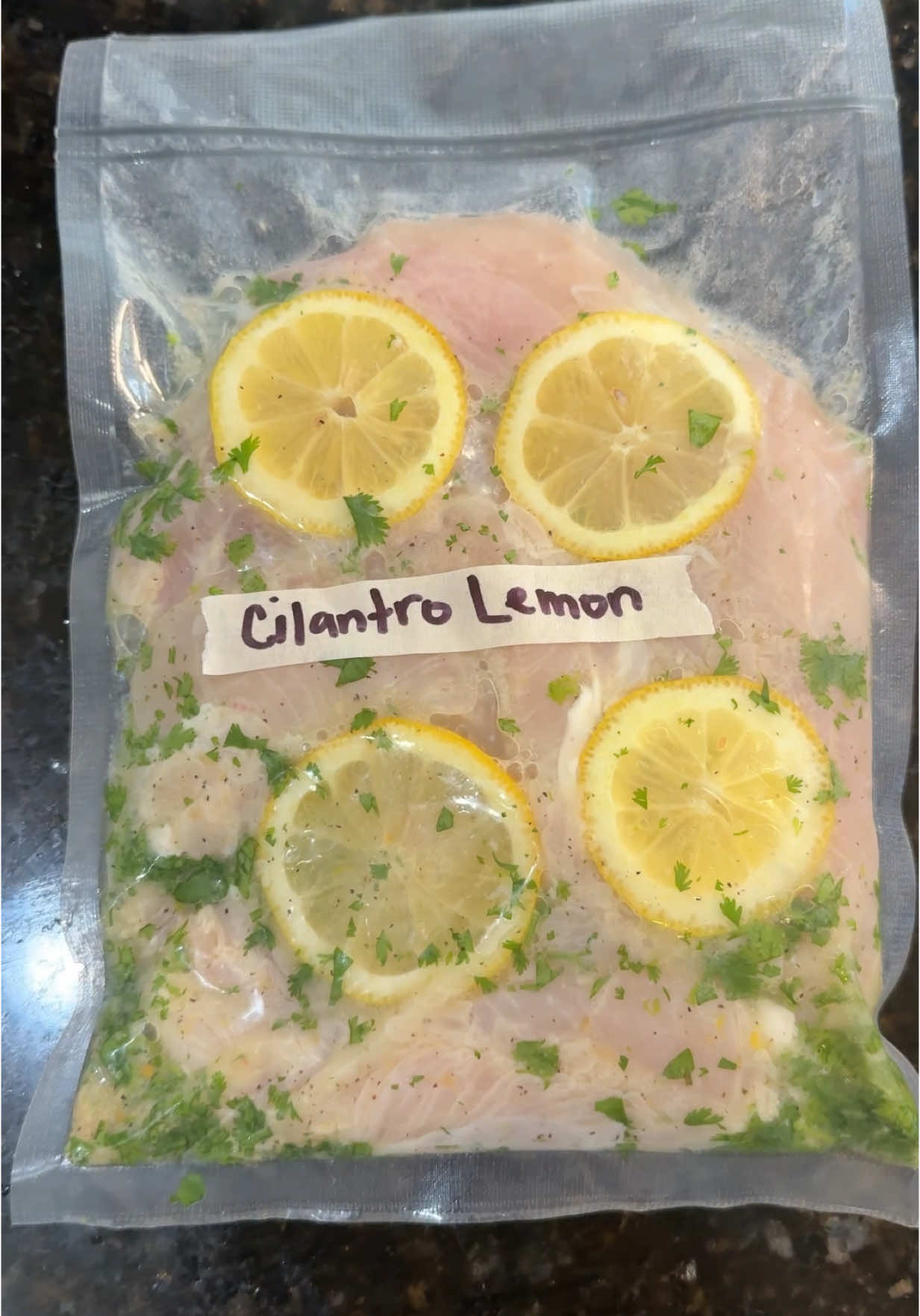 A post by @foodbyjenn on TikTok caption: Freezer Marinade Series: Day 4 – Cilantro Lemon Chicken 🍋🌿 Bright, zesty, and freezer-friendly—this Cilantro Lemon marinade is giving your chicken all the summer energy it needs. Perfect for tossing in the oven, pan, or air fryer when you’re short on time but still want BIG flavor. ✨ Pro tip: Double the batch so you always have a quick, fresh-tasting meal ready to go. 📌 Save this recipe & follow along—new marinade drops every day this week! Cilantro Lemon Marinade Recipe: – 2 chicken breasts – 2 tbsp olive oil – Handful of cilantro leaves – Juice of 2 lemons – Zest of 1 lemon – 1 tsp minced garlic – Lemon slices – Salt & pepper 🧊 Add everything to a freezer-safe bag, seal, and freeze flat. 🔥 Thaw overnight and cook however you like! #FreezerMeals #EasyDinnerIdeas #CilantroLemonChicken #MealPrepMagic #MarinadeSeries #QuickDinners #ChickenRecipes #FamilyMeals #HealthyDinner #FreezerFriendly
